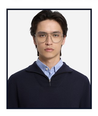 Portrait of a person wearing a navy half-zip knit